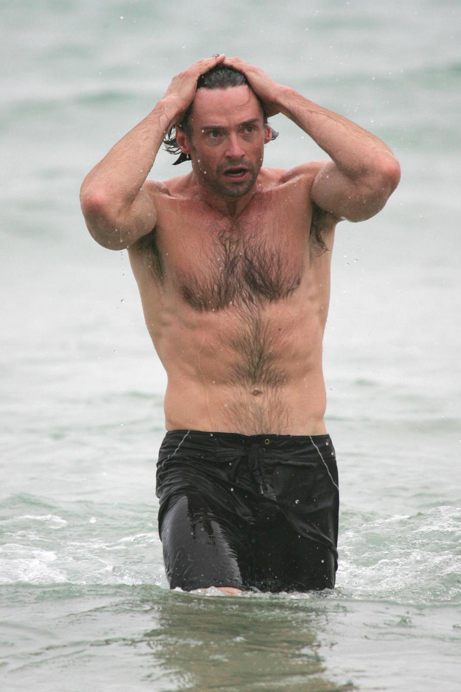 Hugh Jackman shows off his muscles during an early morning dip at Bondi Beach