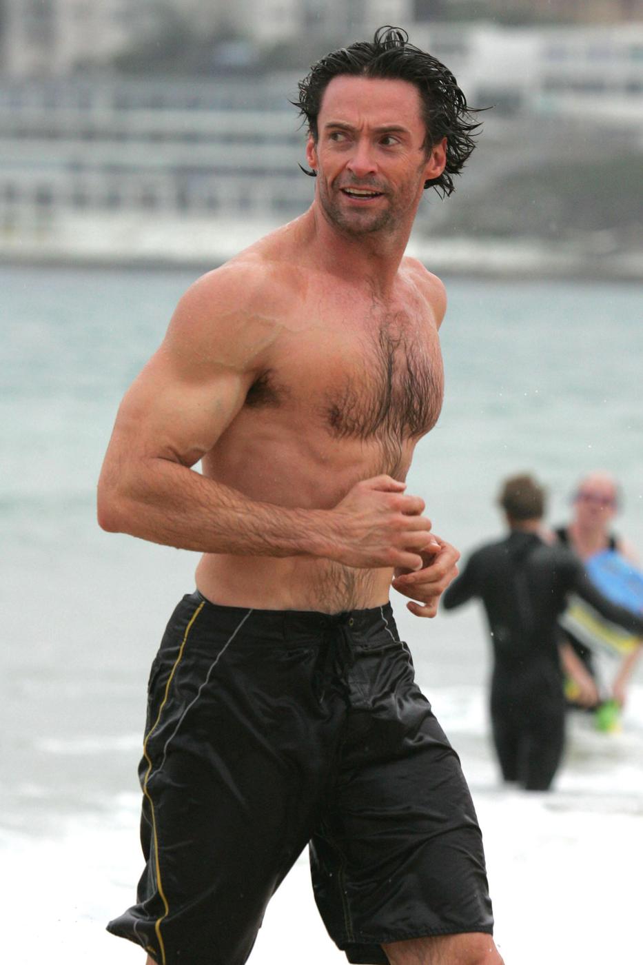 Hugh Jackman shows off his muscles during an early morning dip at Bondi Beach