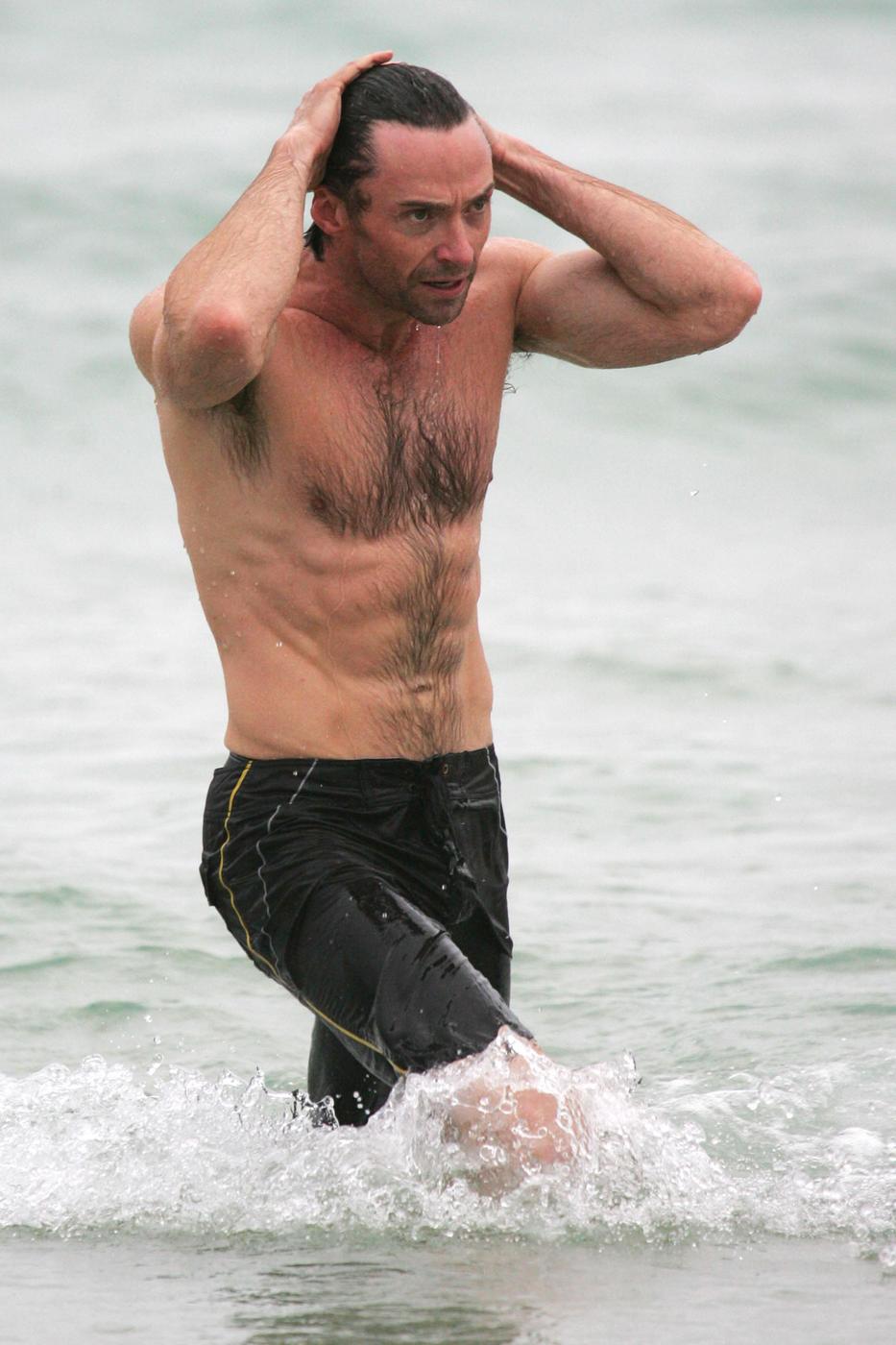 Hugh Jackman shows off his muscles during an early morning dip at Bondi Beach