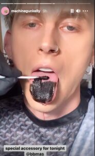 Megan Fox licked Machine Gun Kelly's black tongue on Billboard Music
